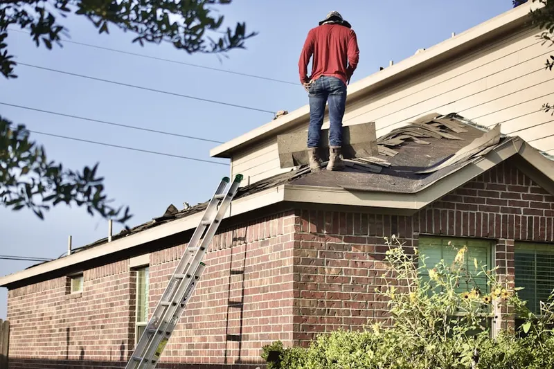 Professional roofer working on a residential roof in Crystal Run Farm